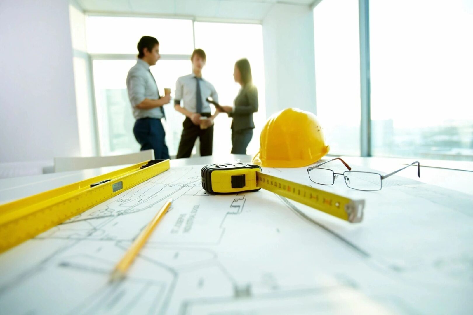 A group of people standing around some construction plans