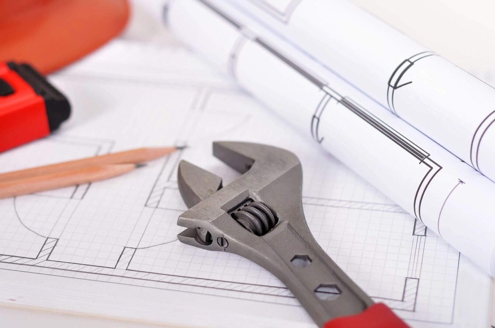 A pair of wrenches sitting on top of construction plans.